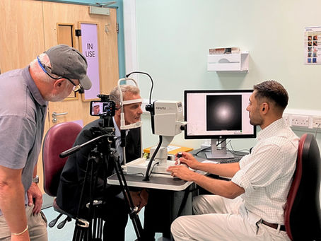 During filming with ITV News at Moorfields Eye Hospital: Ophthalmic surgeon Shafi Balal takes a retinal image of reporter Kevin Ashford using Optical Coherence Tomography (OCT)