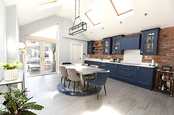 The kitchen of 1 West View, Military Hill, one of Powell Property's previously sold properties, with a brick feature wall and blue cabinets in bright and airy space.
