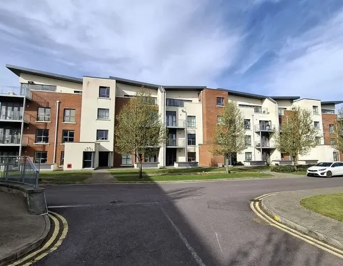 Large apartment building with parking spaces and green spaces, where Apartment 7 Downview is located and for sale in Cork City.