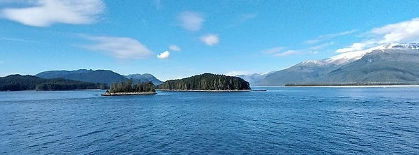 A view from the cruise deck through Alaska's inside passage. Beautiful blue water, snowcapped mountains and clear skies. 