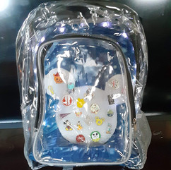 Inside view of a DIY Mickey Mouse shaped foam pin board with Disney trading pins pinned, inside a clear backpack