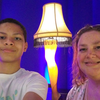 A photo of Zion and I with a famous Christmas Story Leg Lamp at Near West Theater where we saw Legally Blonde.