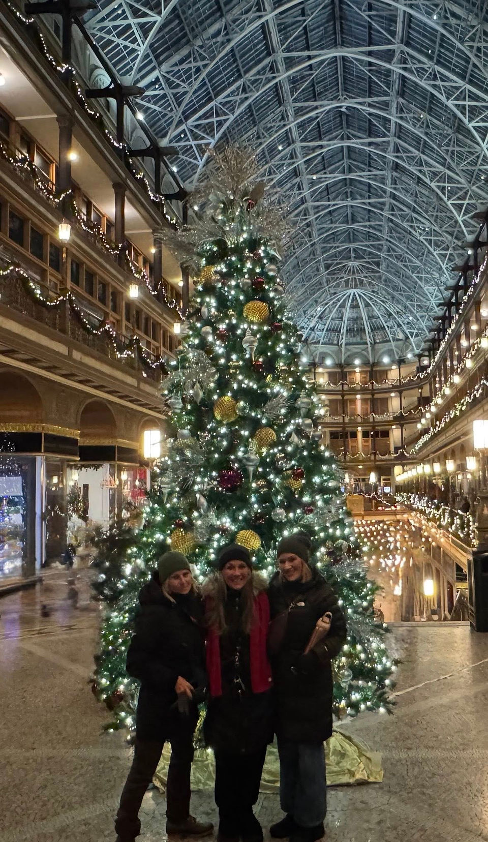 Mara & friends celebrate Christmas in front of the giant decorated  tree in the historic Arcade in Cleveland.
