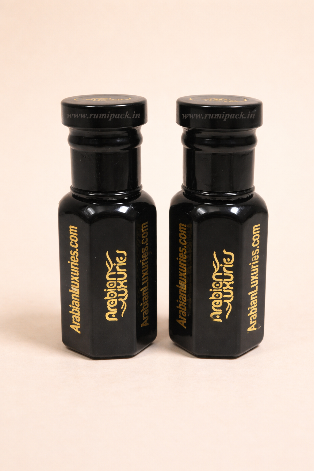 Two black hexagonal bottles with Arabian Luxuries logo