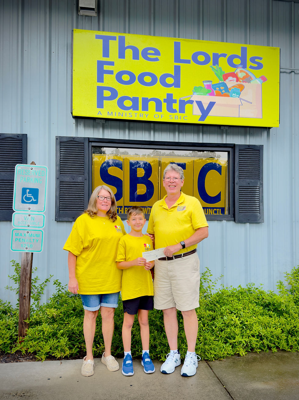 Lisa and Jake Chiulli present Dan Shaw with a Capital Campaign donation 