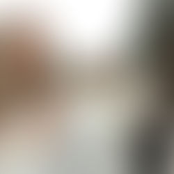 Three girls in white dresses stand outside and look up.