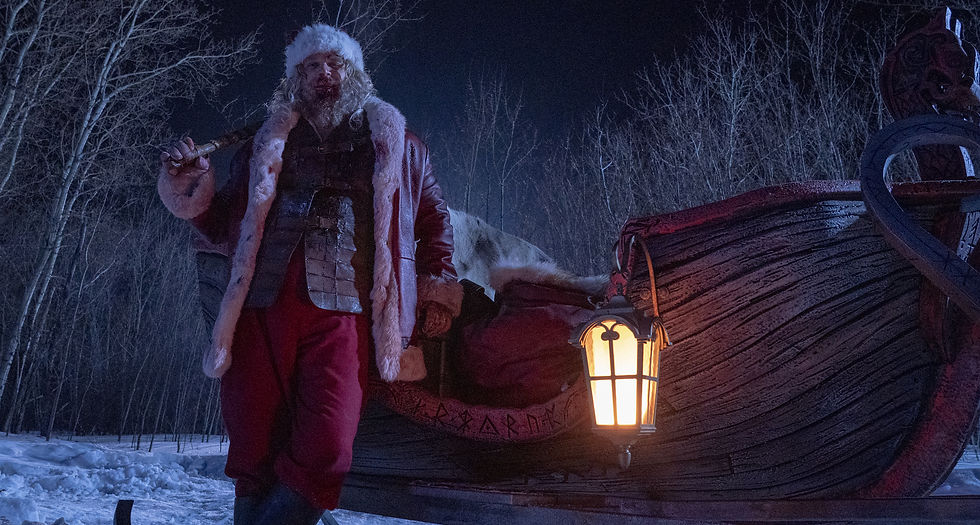 A bloody santa leans against a sleigh