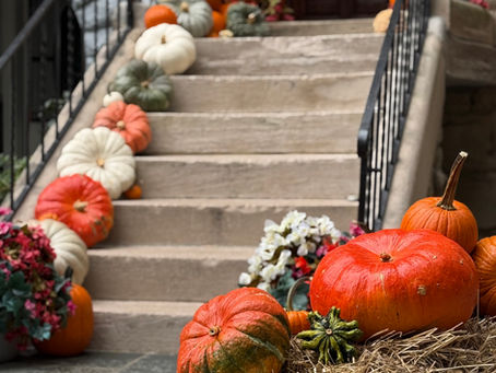 Custom Classic fall front porch decorated with pumpkins, mums and seasonal decor by Pumpkin City Designs in Maryland