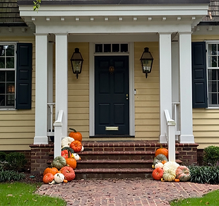 Pumpkins of various colors on front steps for porch decorating