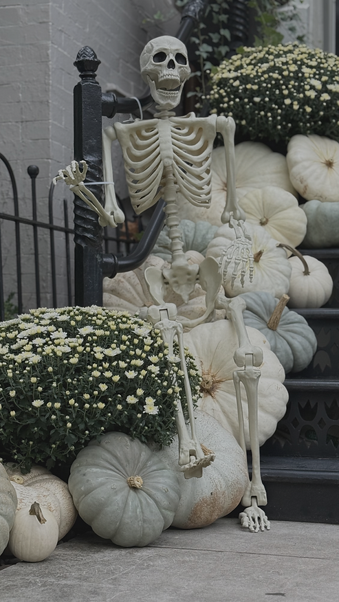 Skeleton and white pumpkin porch decorating on steps