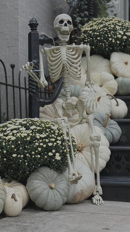 Skeleton and white pumpkin porch decorating on steps