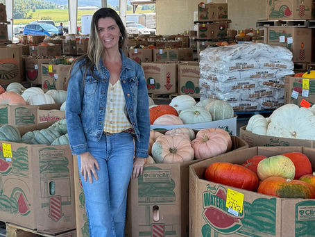 Stephanie Nucci selecting Premium Pumpkins for custom fall porch decorating displays in Maryland