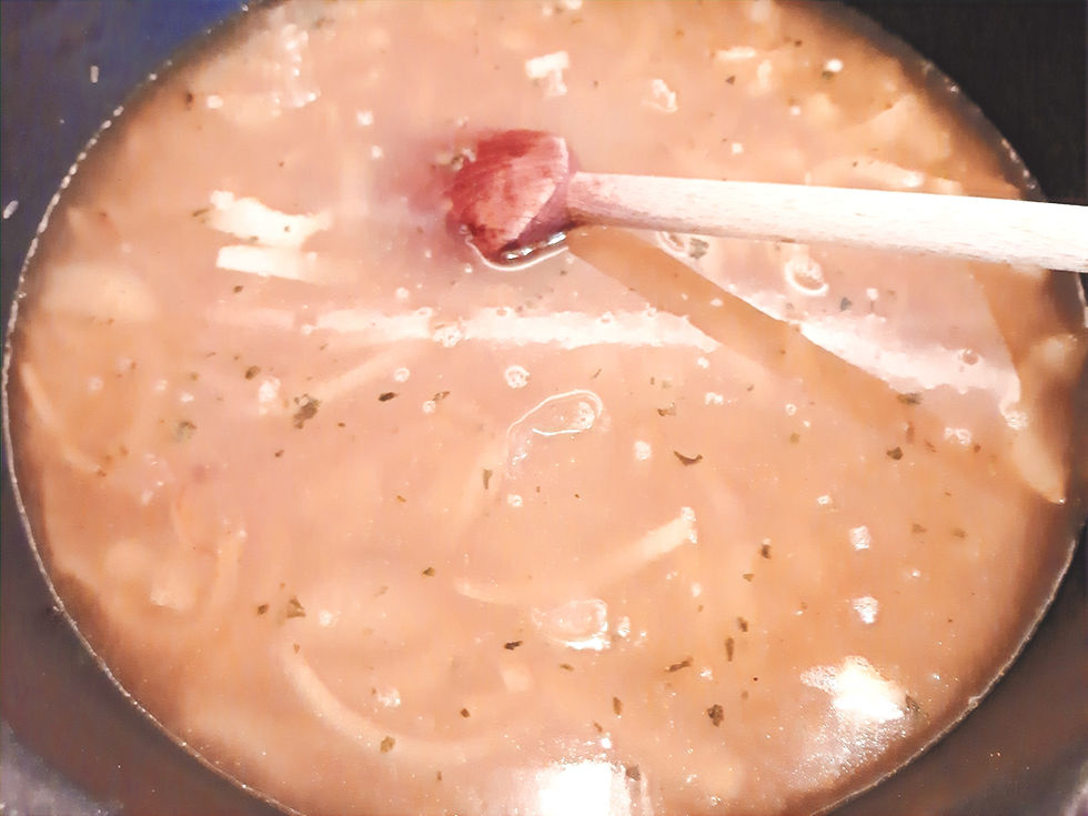 Mélange de riz, oignon et épices recouvert d'eau dans une casserole