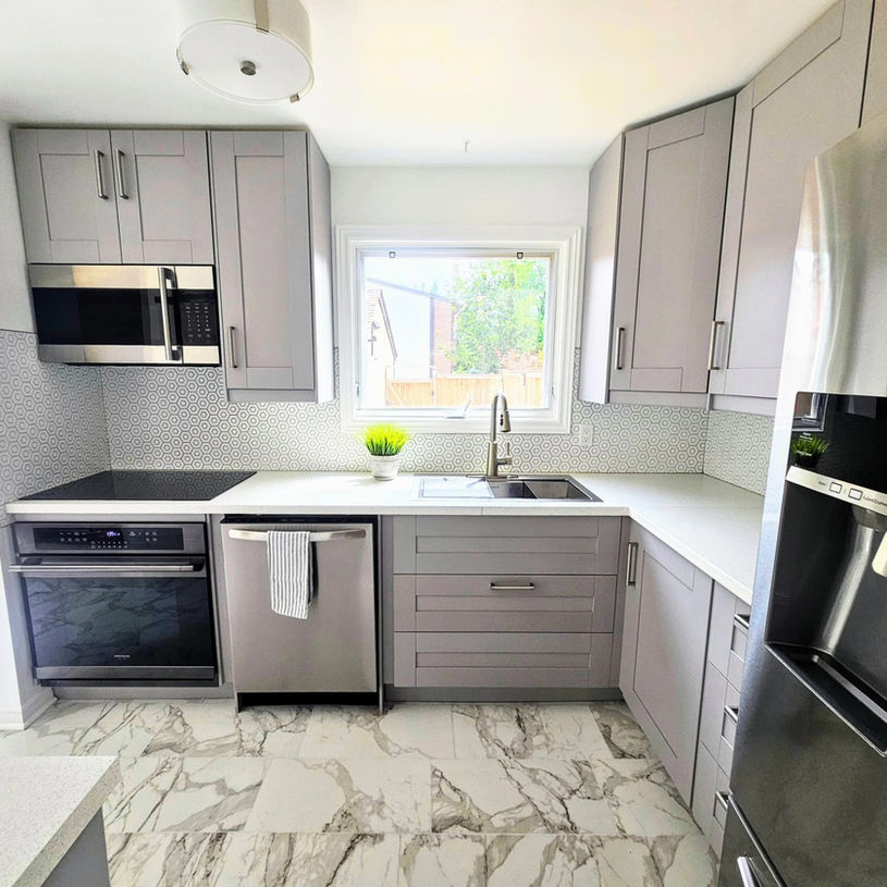 Modern kitchen with gray cabinets and marble floor