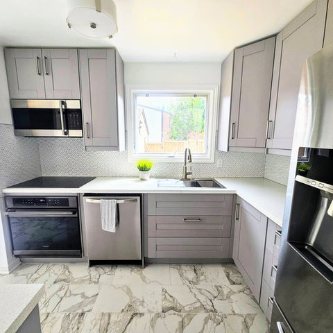 Modern kitchen with gray cabinets and marble floor