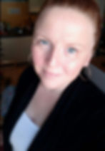 Smiling woman with red hair and hoop earrings. Kristina VanVelthoven. The owner of Kristina's Cleaning Solutions.