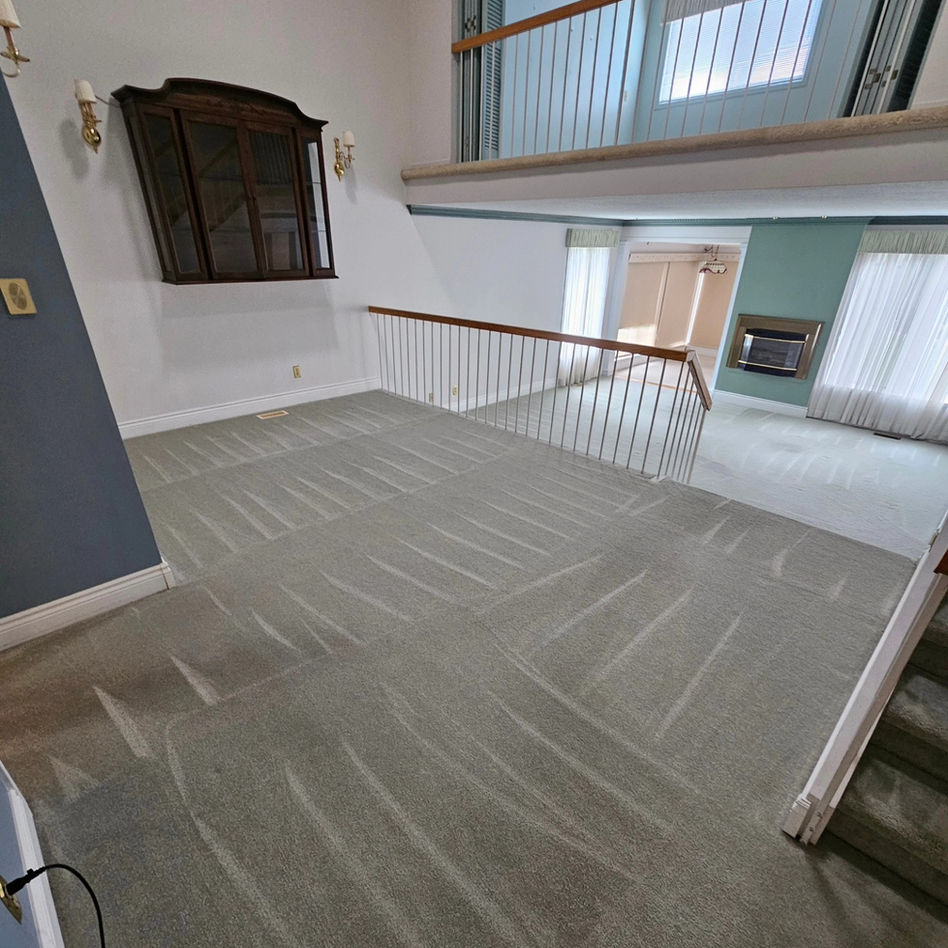 Spacious home interior with gray carpeting