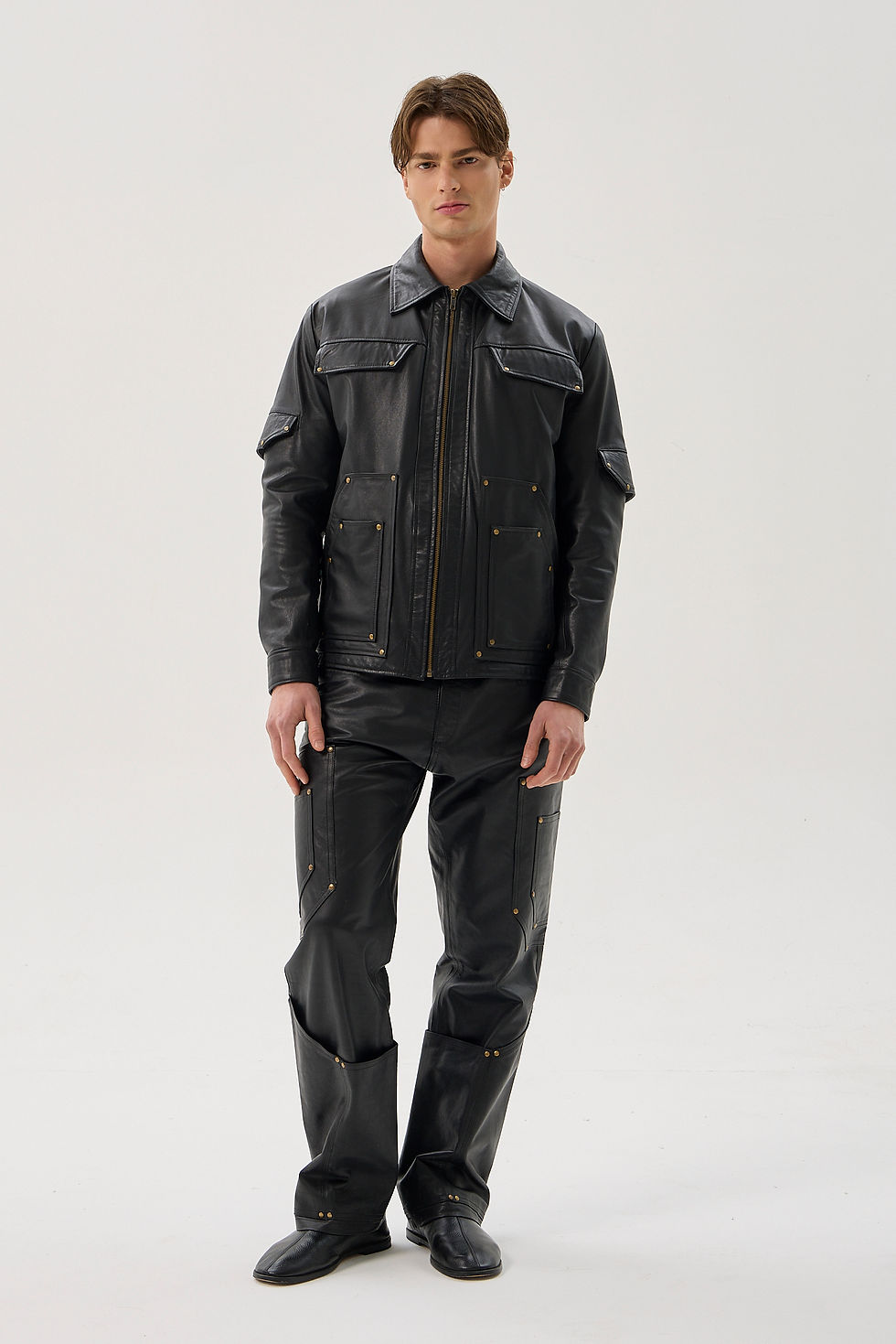 Black calfskin utility jacket with reinforced pockets and brass hardware