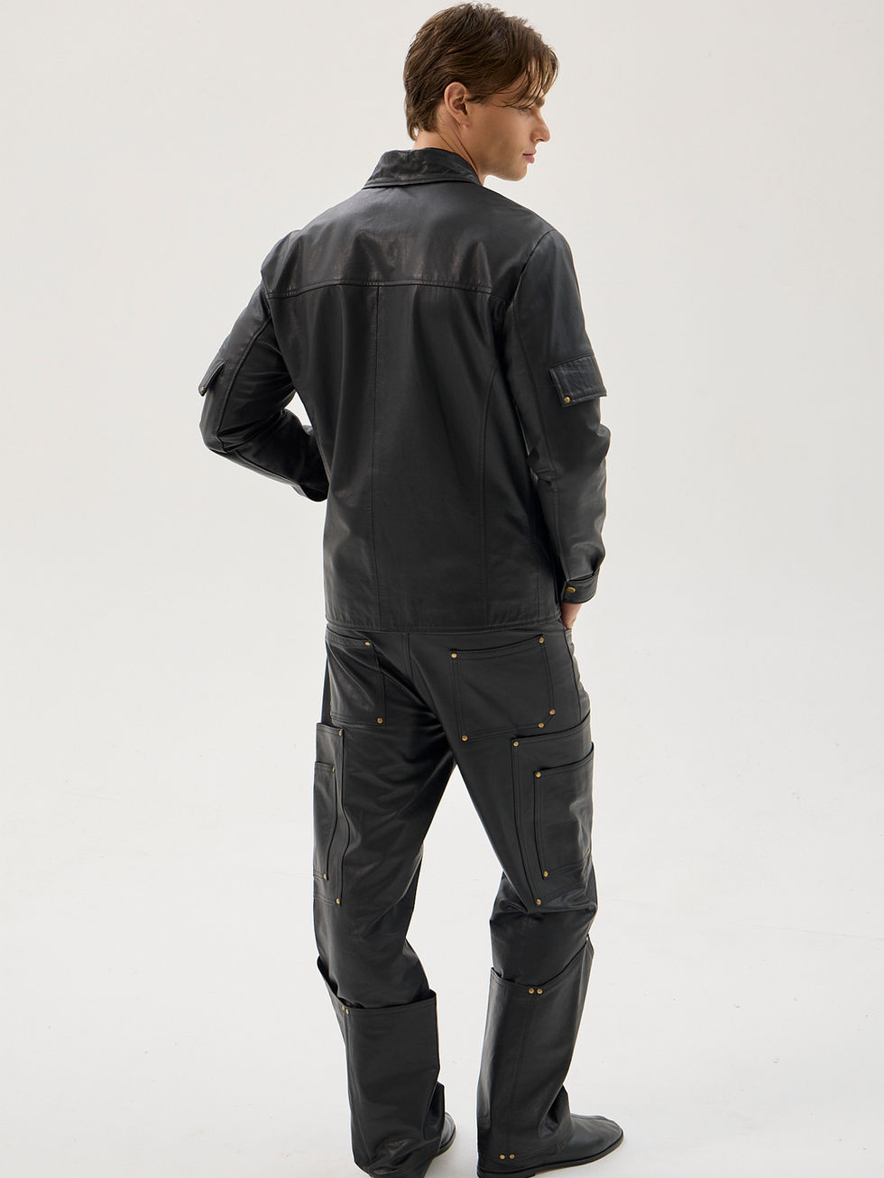 Black calfskin utility jacket with reinforced pockets and brass hardware
