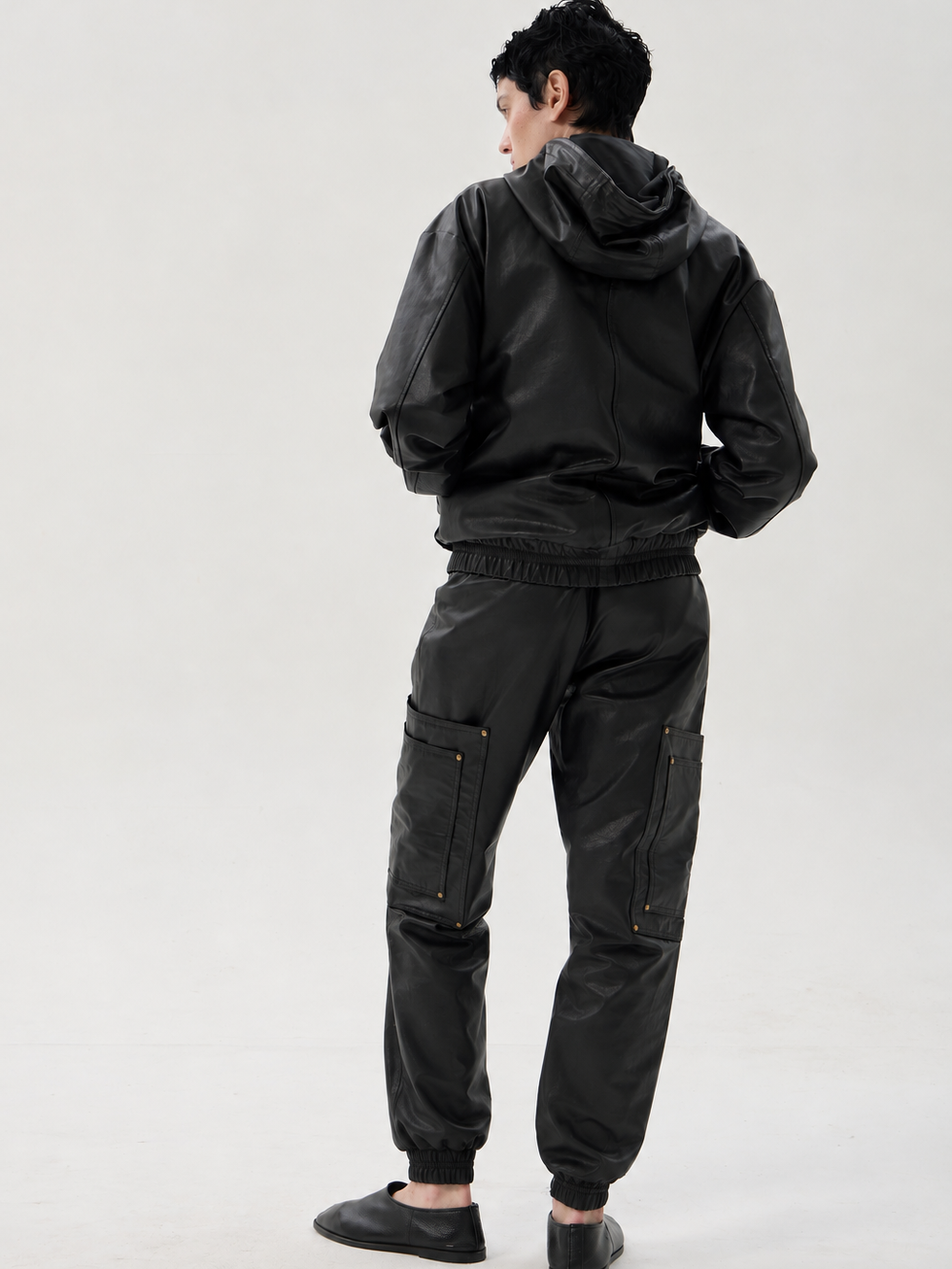 Black calfskin cargo pants with elastic waist and cuffs, oversized pockets and riveted detailing