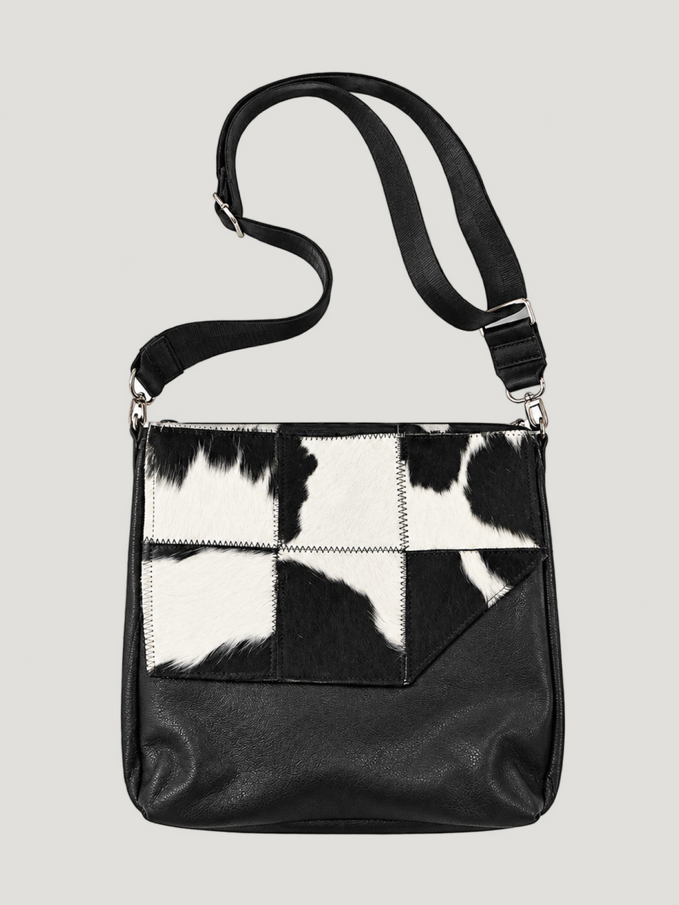 Full-grain Napa calfskin crossbody bag with geometric cowhide-patterned paneling