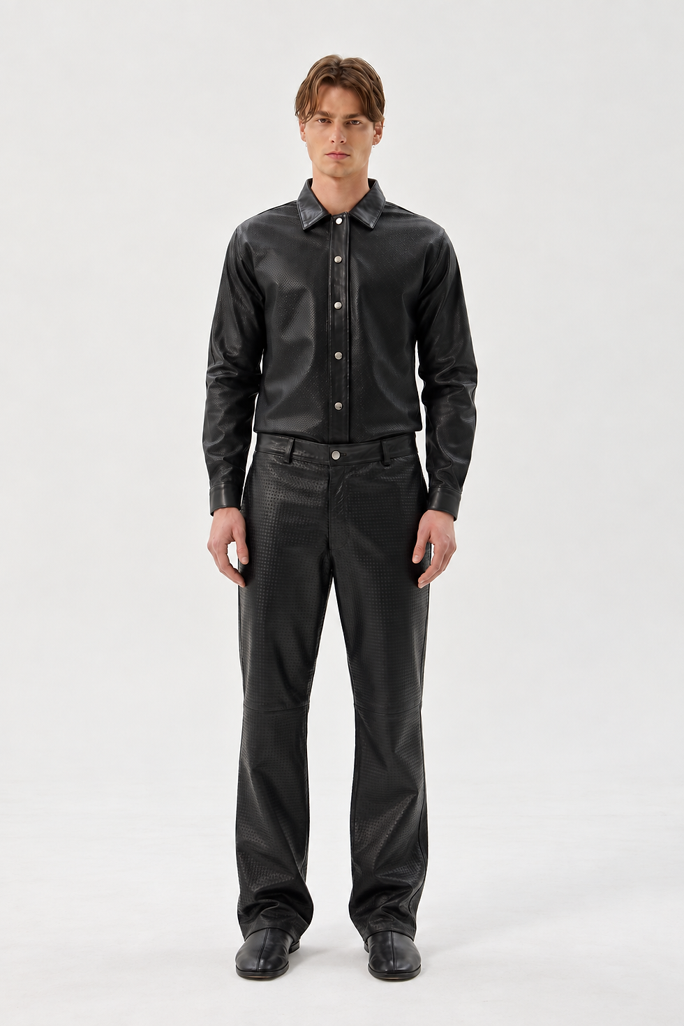 Black perforated sheepskin shirt with a classic collar, front snap closure, and curved hem