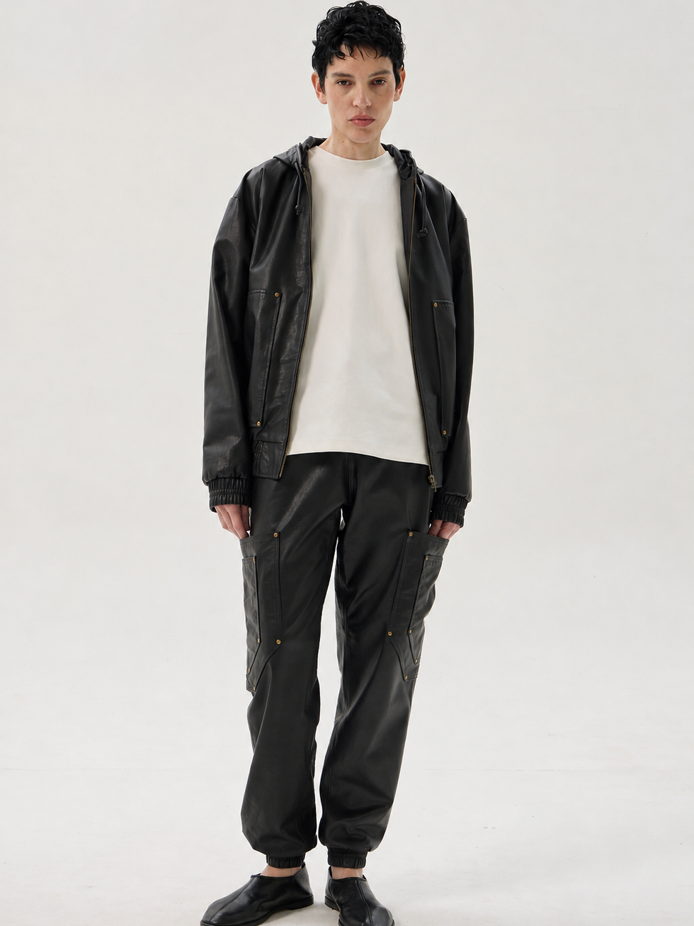 Black calfskin cargo pants with elastic waist and cuffs, oversized pockets and riveted detailing