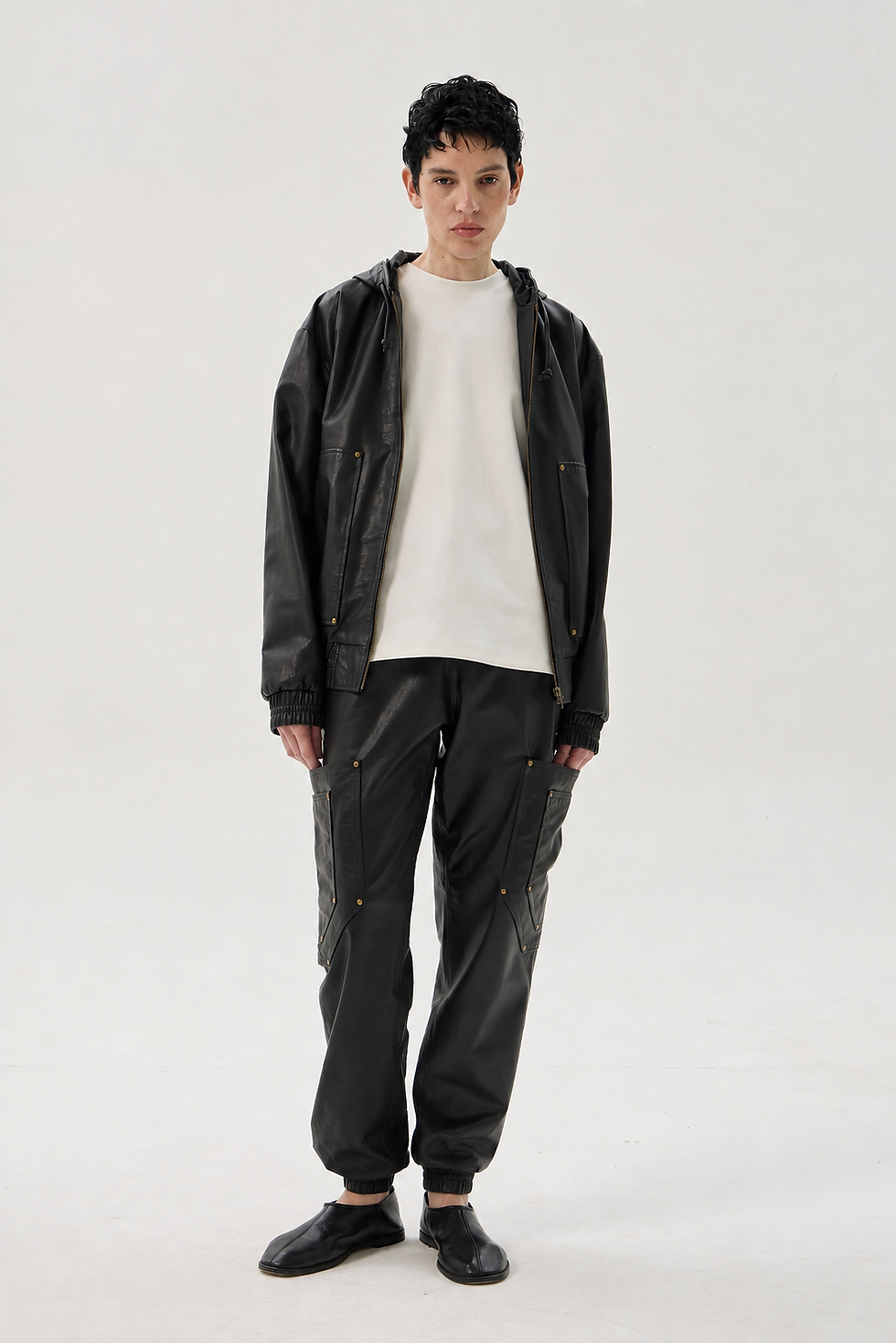Black calfskin cargo pants with elastic waist and cuffs, oversized pockets and riveted detailing