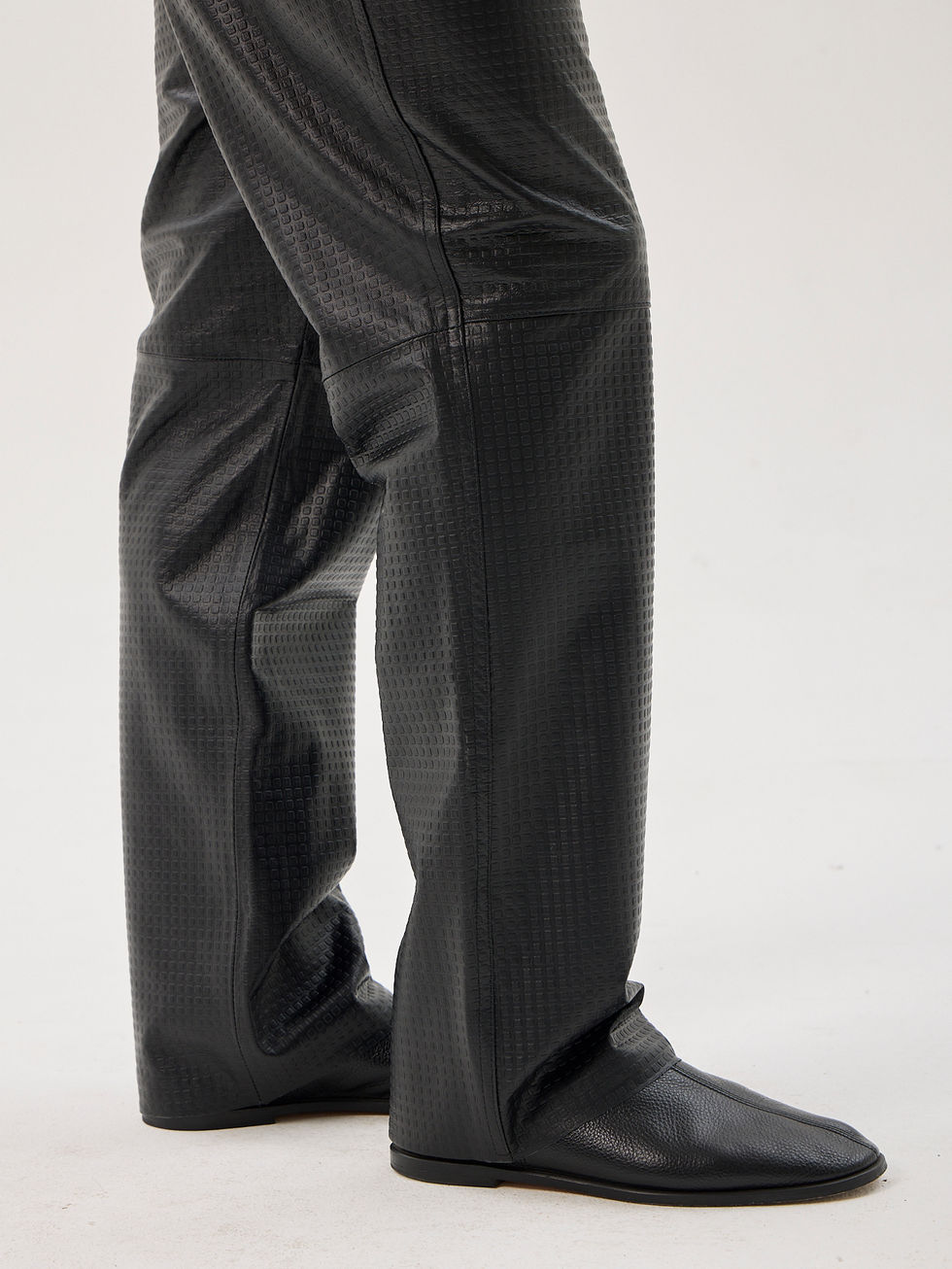 Black calfskin straight leg trousers with laser-cut detailing