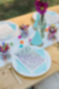 Decorated party table with flowers, plates and crayons