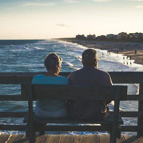 man and woman sitting on bench in front of beach_edited.jpg