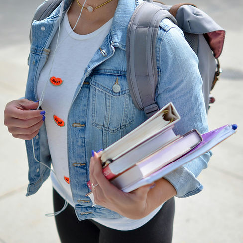 woman wearing blue denim jacket holding book_edited.jpg