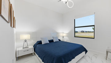Comfortable guest bedroom with natural light in a modern Port St. Lucie luxury home.