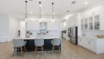 Wide kitchen island and bar seating view with pendant lights in Port St. Lucie real estate photography