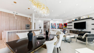 Modern dining area and open living space photographed in high-end oceanfront condo