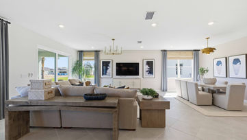 Living room with sectional sofa and open floor plan in Port St. Lucie model home