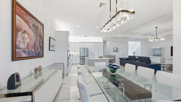 Modern dining area connected to the open living space in a Port St. Lucie luxury residence.