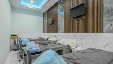 Private spa treatment beds with marble finishes inside Tipsy Nails & Bar in West Palm Beach