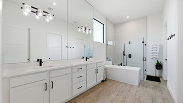 Luxury primary bathroom with double vanity and modern fixtures photographed in Port St. Lucie Florida