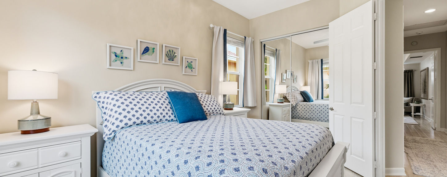 Guest bedroom in a Palm Beach condo featuring bright coastal décor.