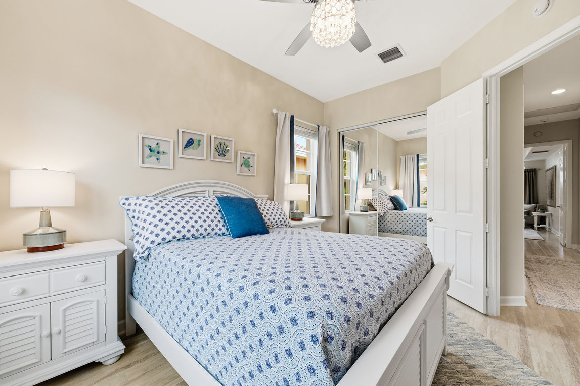Guest bedroom in a Palm Beach condo featuring bright coastal décor.