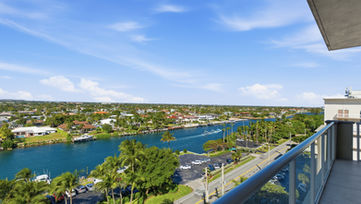 Luxury condo balcony view overlooking Intracoastal waterway and waterfront homes in South Florida, photographed by Edwin Figueroa Photography.