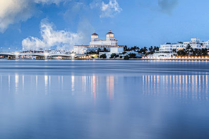 Palm Beach Island waterfront mansion with reflections on calm water photographed by Edwin Figueroa Photography serving West Palm Beach Florida