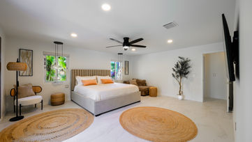 Luxury primary bedroom with modern decor and garden views in Delray Beach Florida