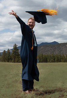 Eric throwing grad cap towards camera