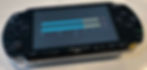 Black Sony PSP showing the TRAX level meters, left and right bars on a decibel scale