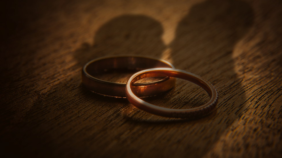 Couple's shadows romantically standing over rings. Leads to about section.