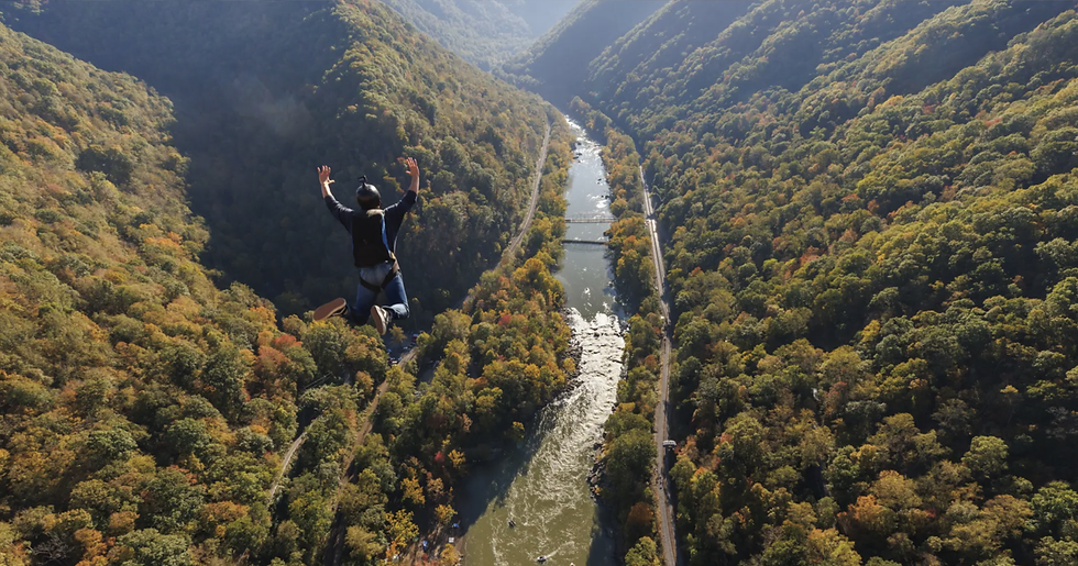A man parachutes from New River Gorge Bridge during Bridge Day.