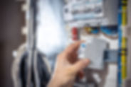 male-electrician-works-switchboard-with-electrical-connecting-cable.jpg