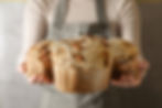 Eye-level view of a freshly baked Colomba di Pasqua on a rustic wooden table